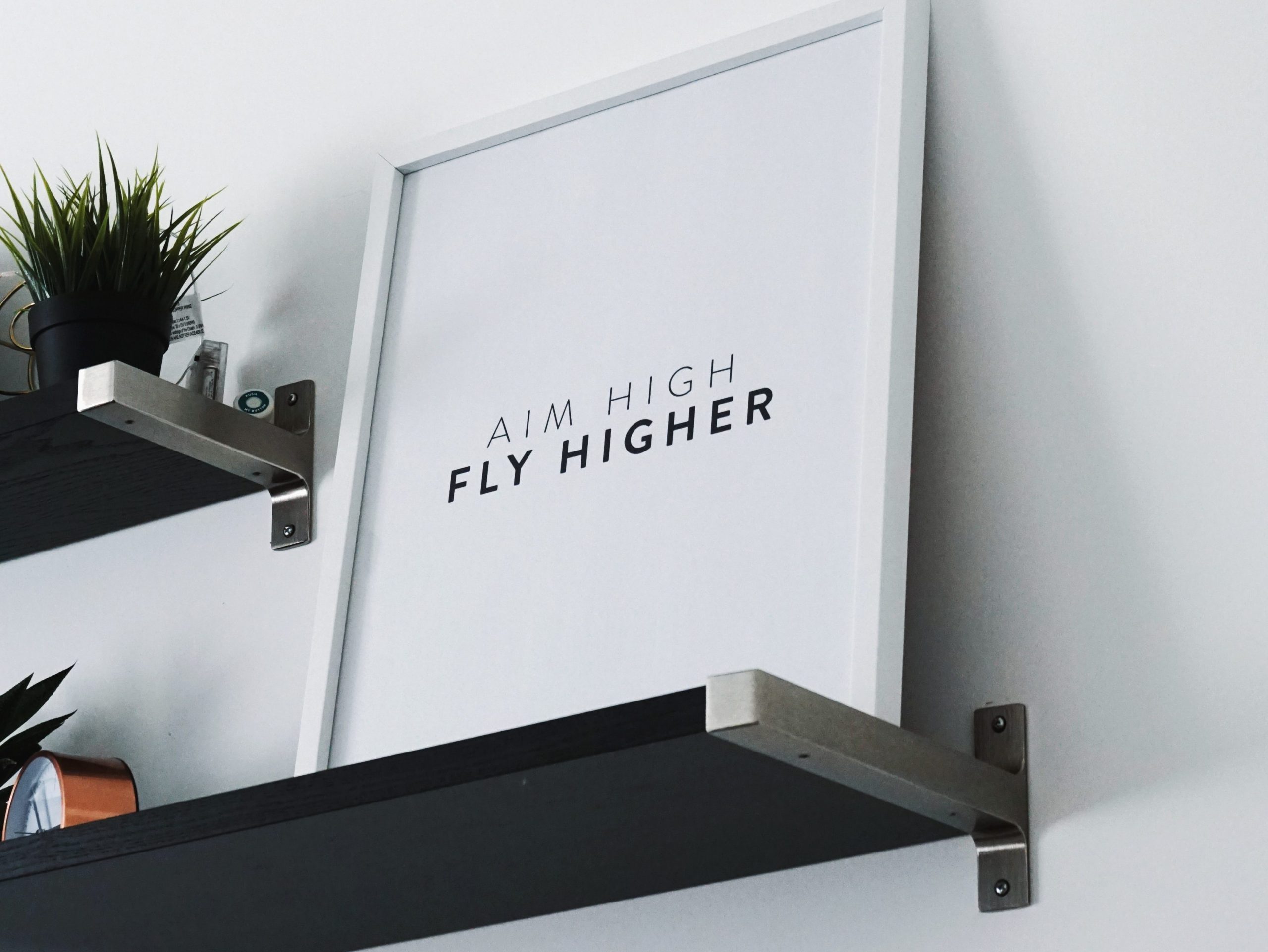 framed art stating aim high, fly higher