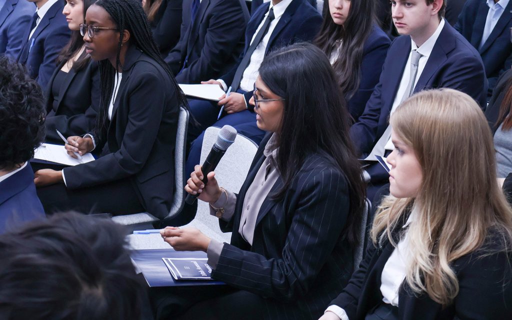 Finance student Vibeke Iyer '27 asks a question during the Finance Society's trip to Wall Street last week. (Samuel Martin)